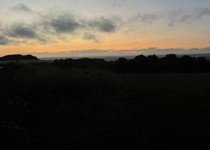 Sunset over a dark landscape