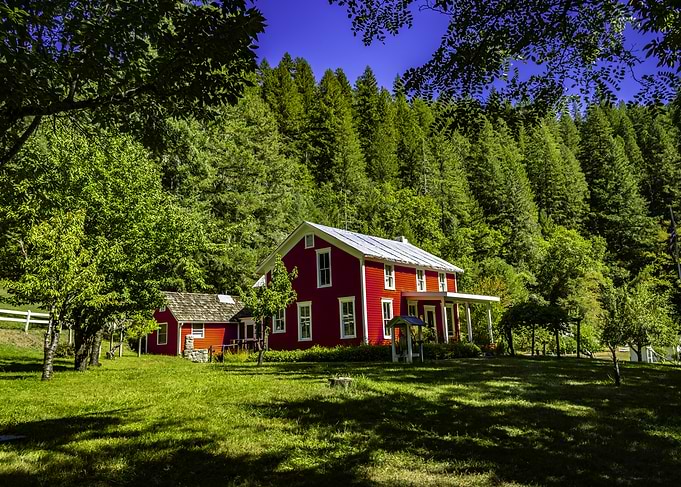Red Farmhouse in Green Landscape