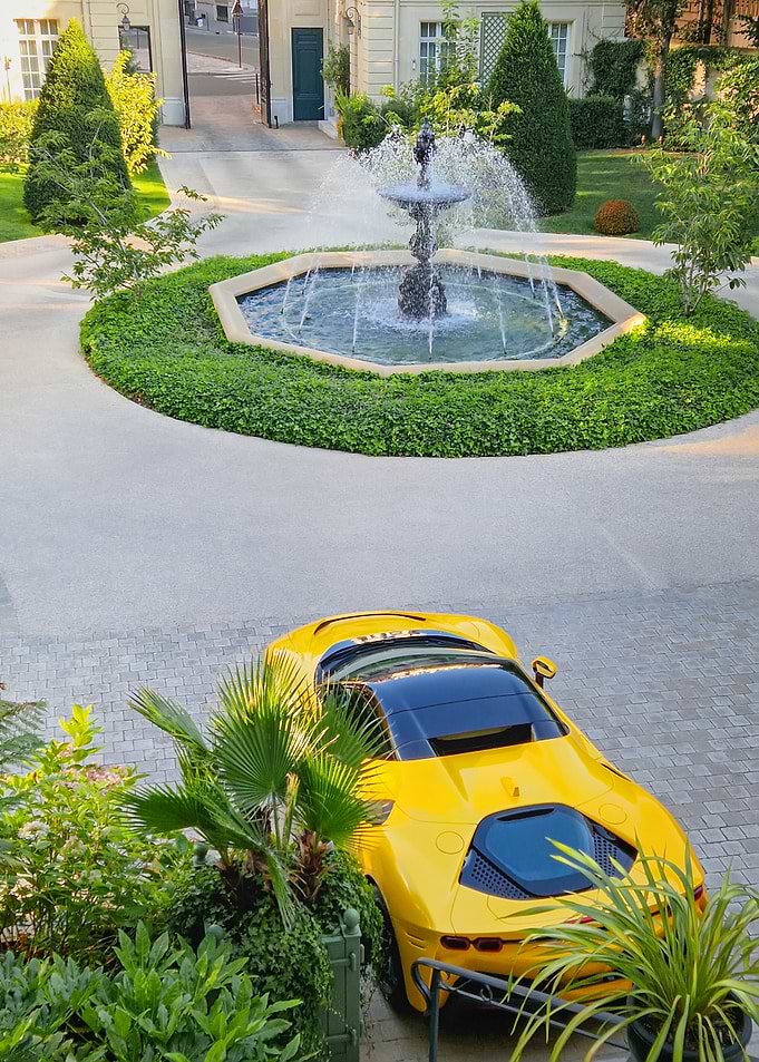 Yellow Sports Car by Fountain