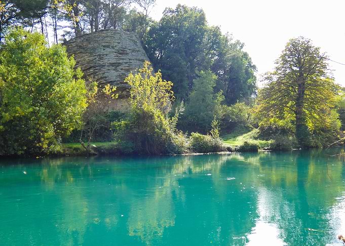 Photography of Turquoise River Landscape with Rock Formation