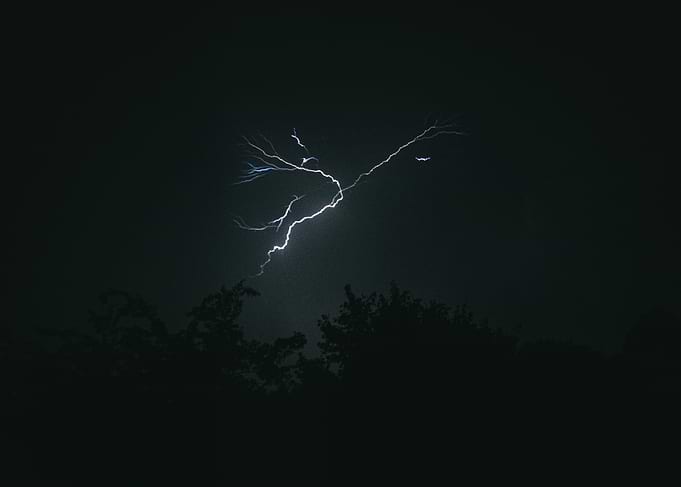 Lightning Strike Over Trees at Night