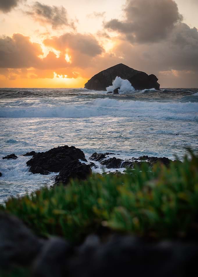 Coastal Sunset with Island and Waves
