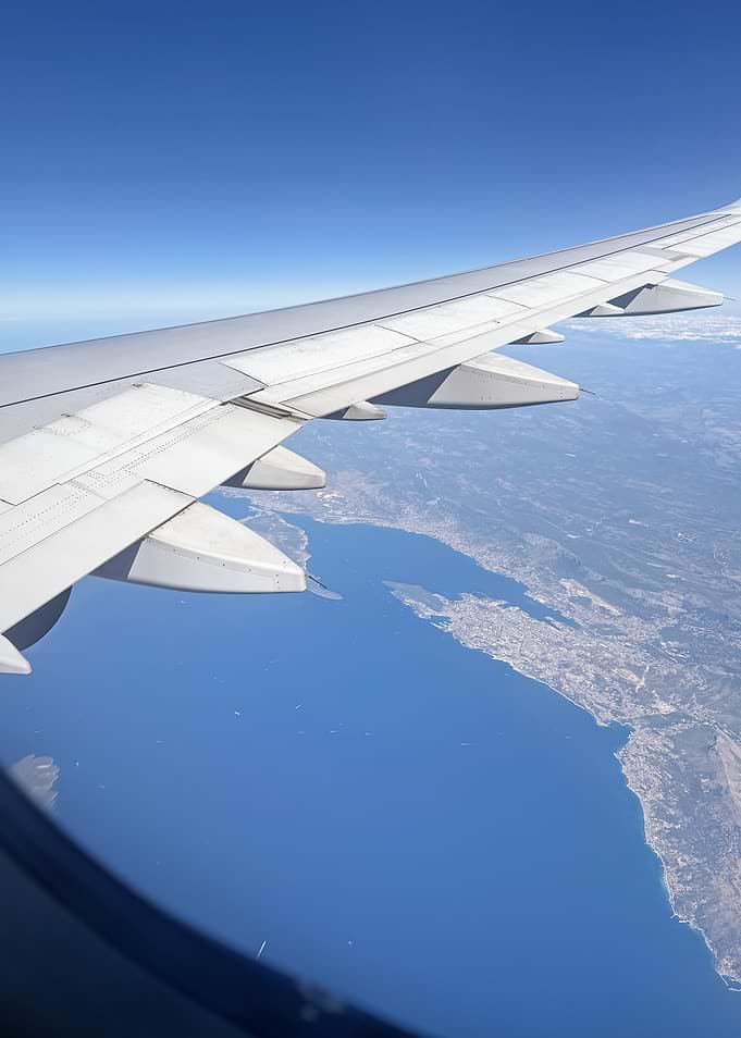 Airplane Wing Over Coastline