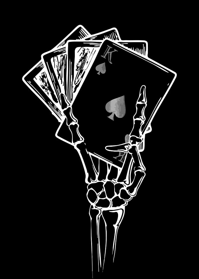 Skeleton Hand Holding Playing Cards