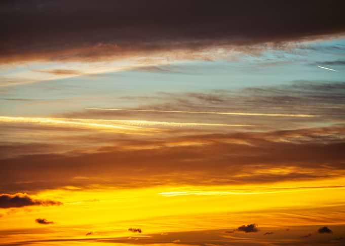Dramatic Sunset Sky with Contrails