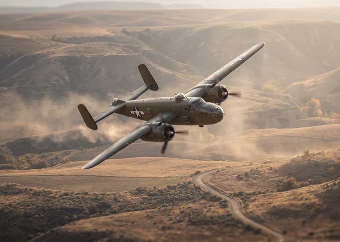 B-25 Mitchell over golden landscape