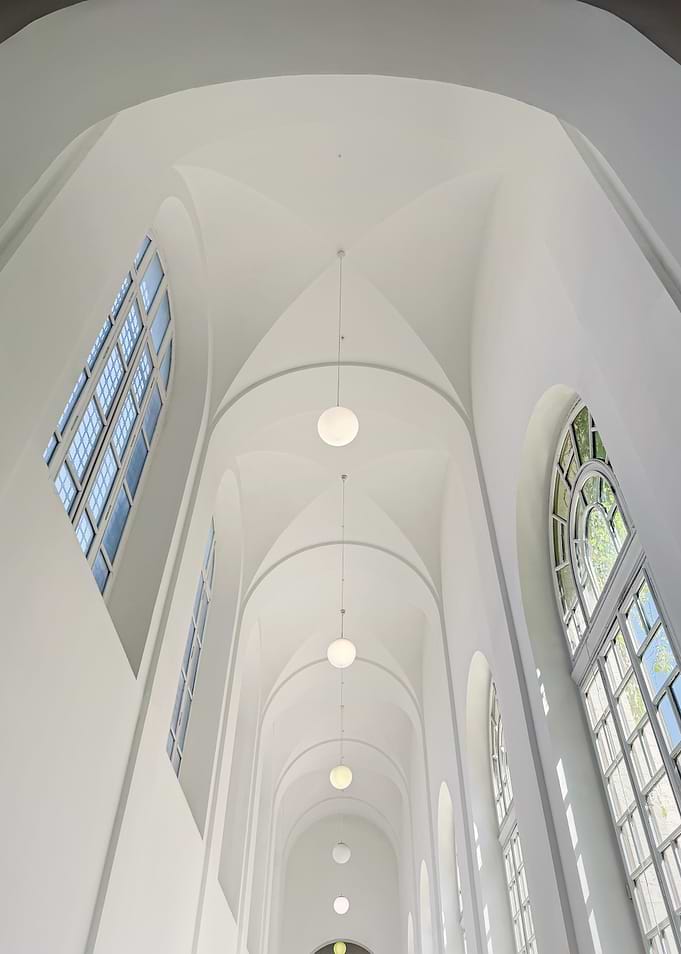 White Arched Hallway with Globe Lights