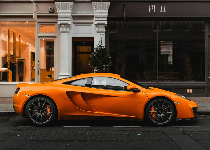 Orange McLaren MP4-12C parked on the street