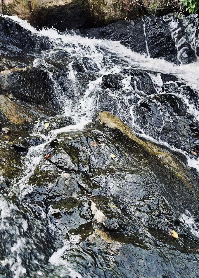 Water Flowing Over Dark Rock