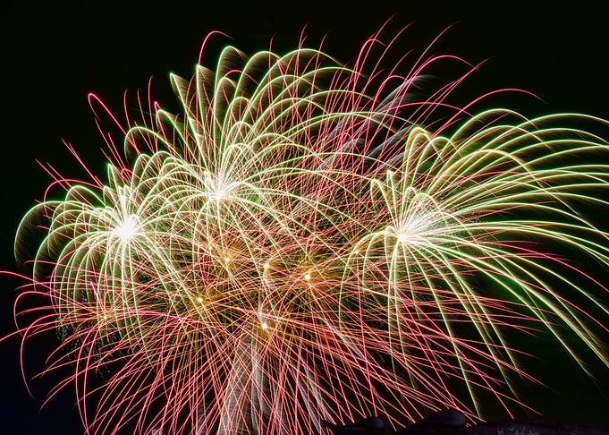 Large, colorful green and red fireworks at 'Hamburger DOM'