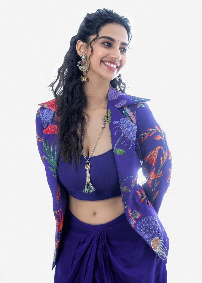 meenaakshi Smiling Woman in Blue Floral Outfit
