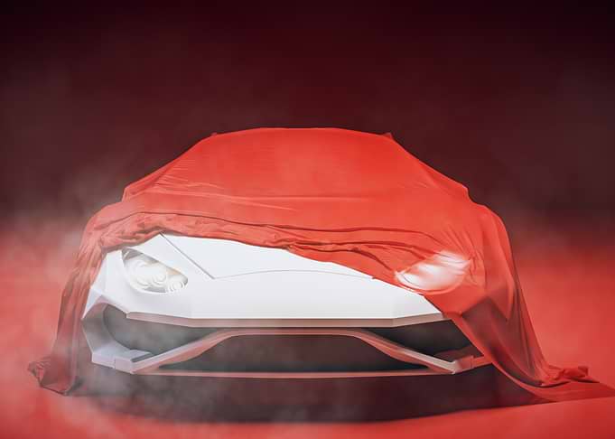 Concept Car Unveiling Under Dramatic Red Drape in Studio