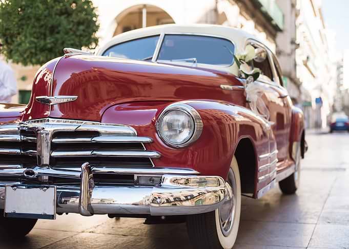 Vintage Romance: Ruby Red Classic Car Decorated for a Wedding