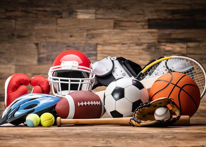 Assorted Sports Equipment on Wooden Surface
