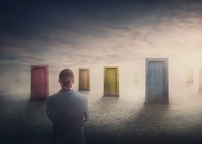 Man Facing Multiple Doors in Fog