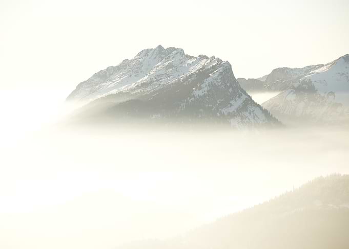 Snowy Mountain Peaks in Fog
