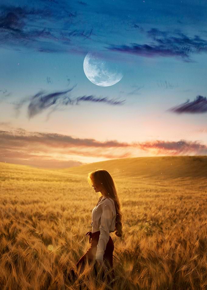 Woman in wheat field under moon