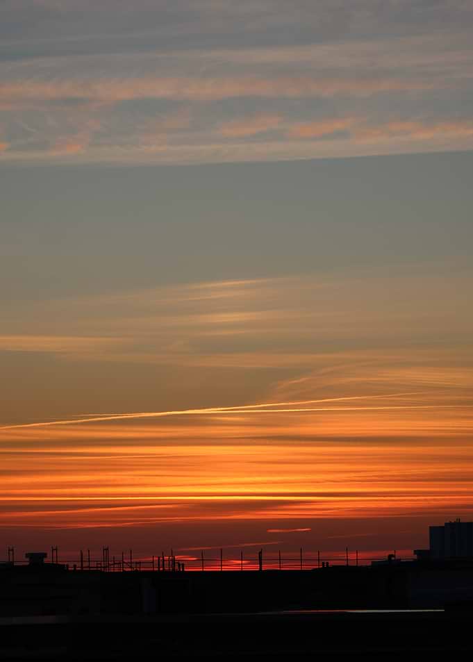 Fiery Sunset Over City Silhouette