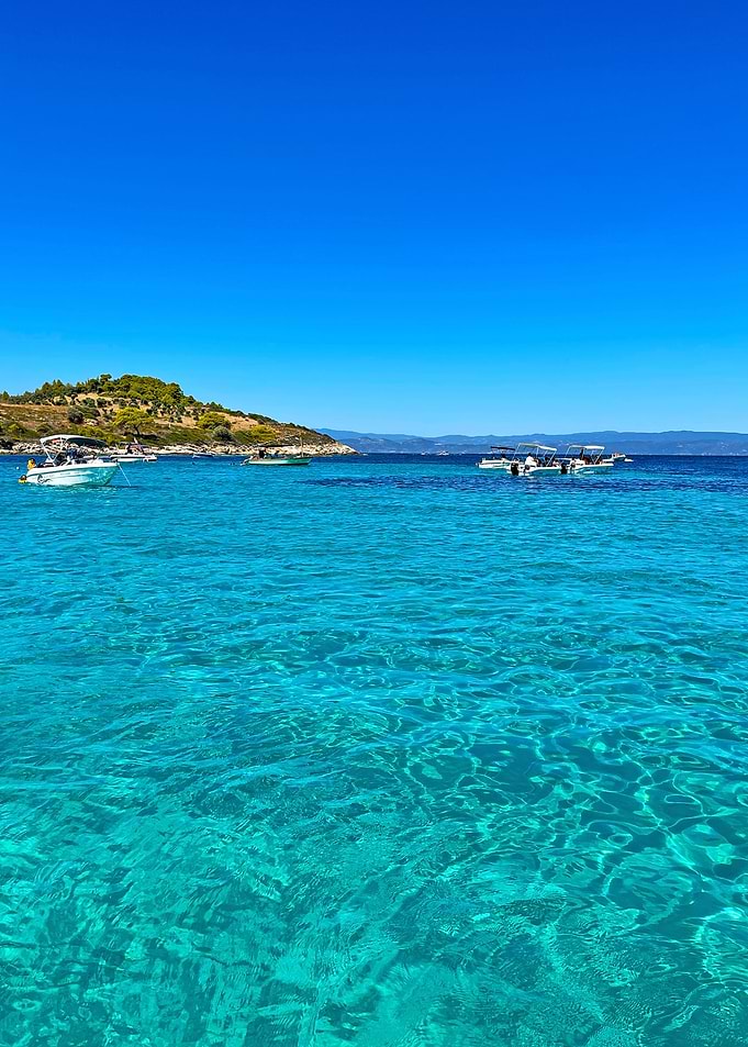 Turquoise Sea with Boats and Island