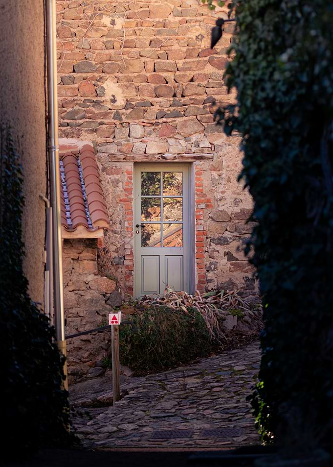 Stone Building with Doorway and Cobblestone Path