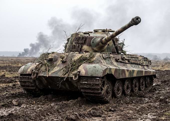 Camouflaged Tank in Muddy Field