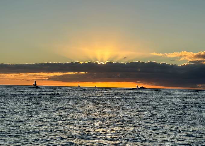 Ocean Sunset with Sailboats and Clouds