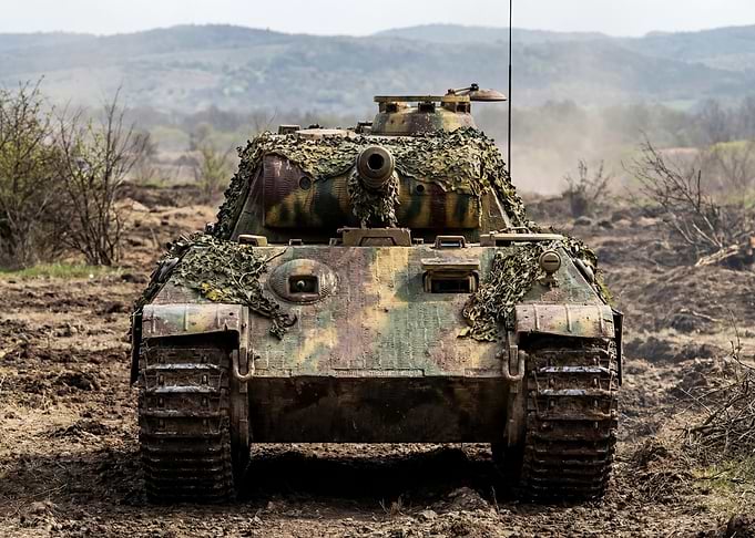 Camouflaged Tank in Field
