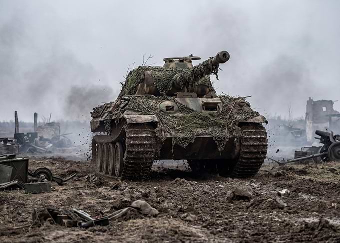 Camouflaged Tank in War-Torn Landscape