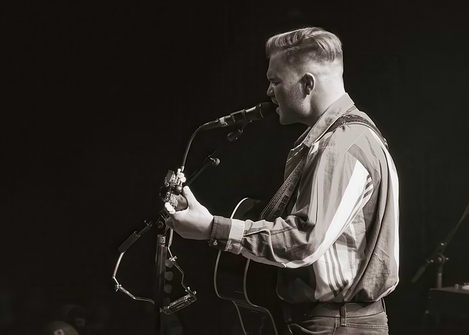 Musician performing with guitar and microphone