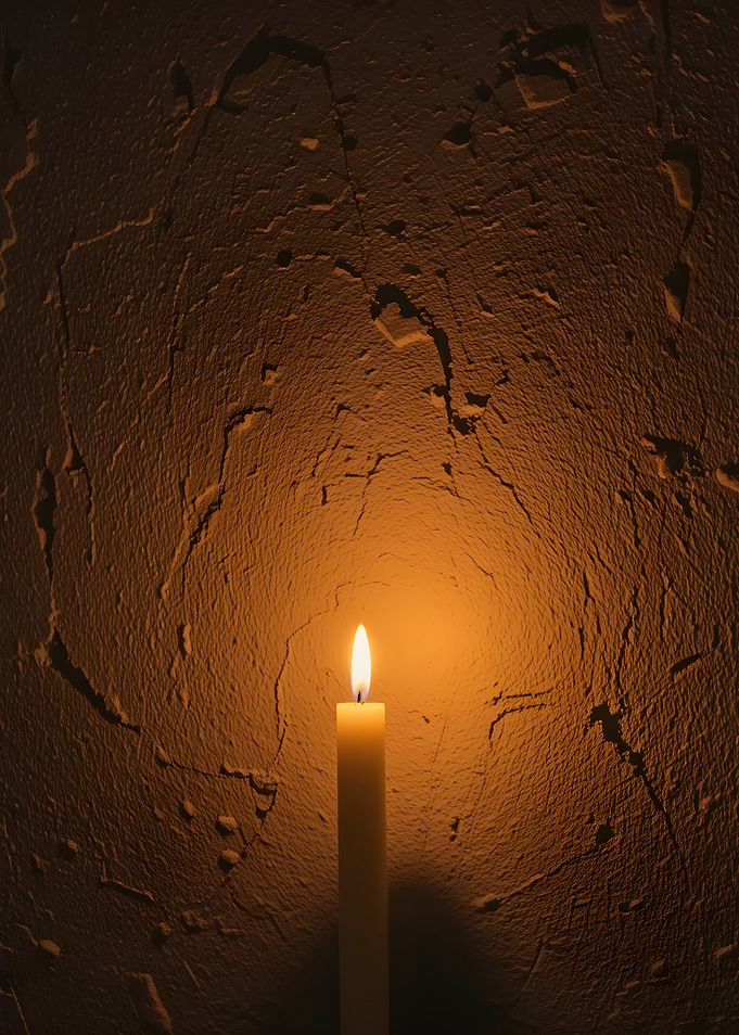 Candlelight against textured wall