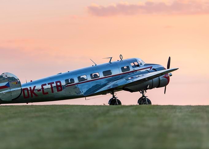 Vintage Airplane on Grassy Field