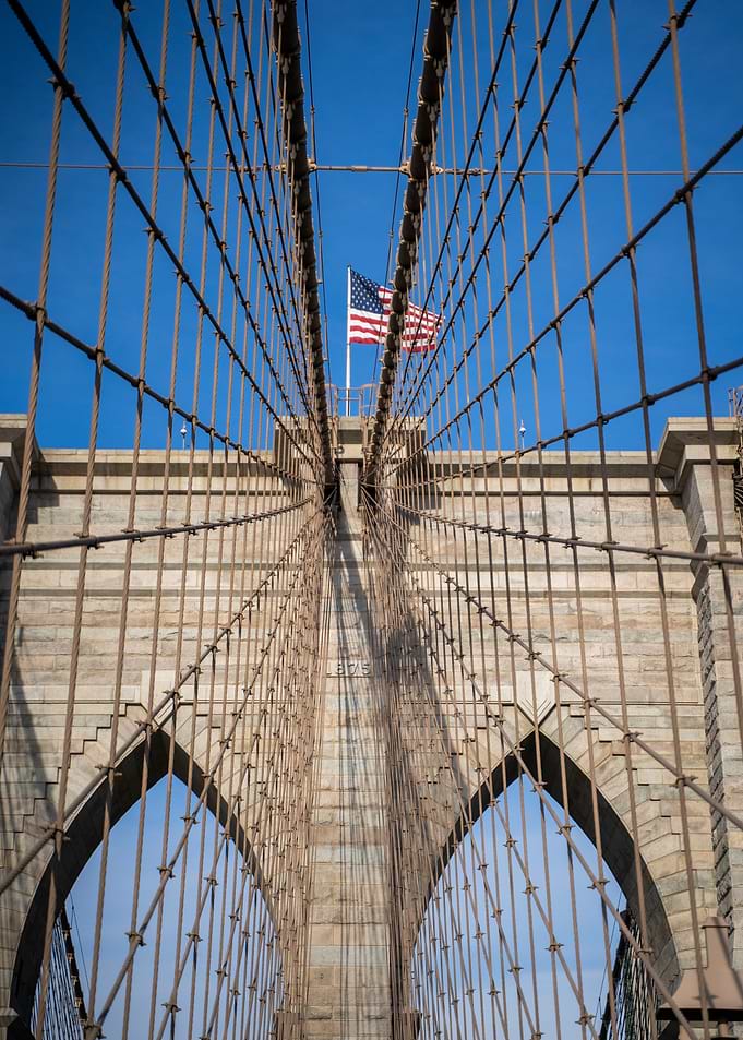 Brooklyn Bridge, New York with American Flag
