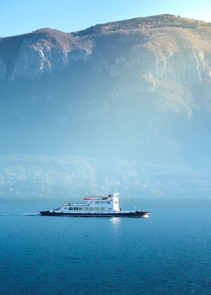 Ferry on Lake with Mountain Backdrop