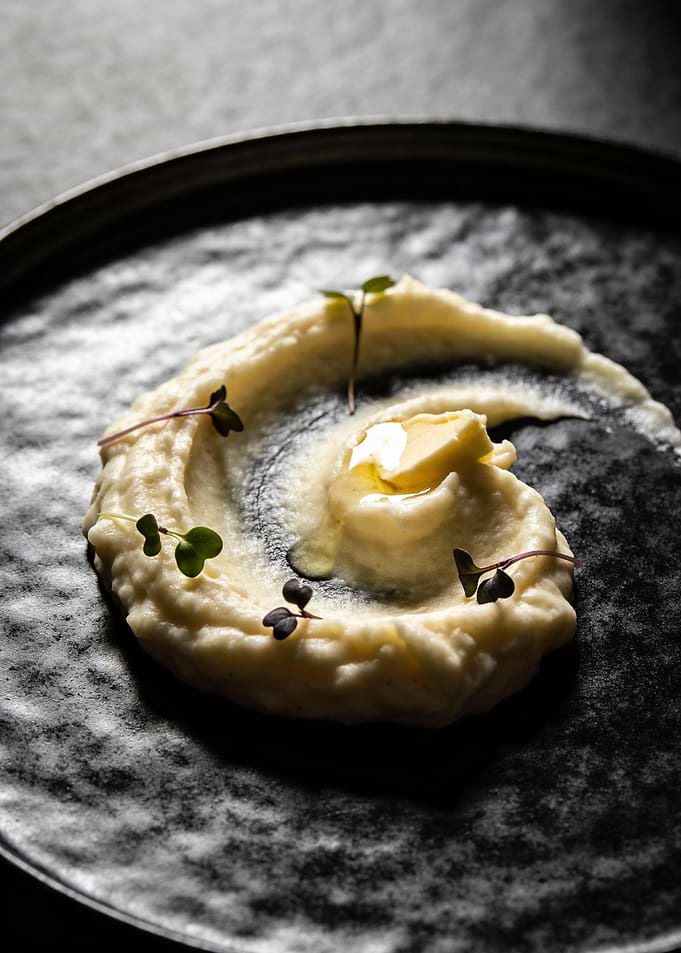 Elegant Mashed Potatoes on Black Plate