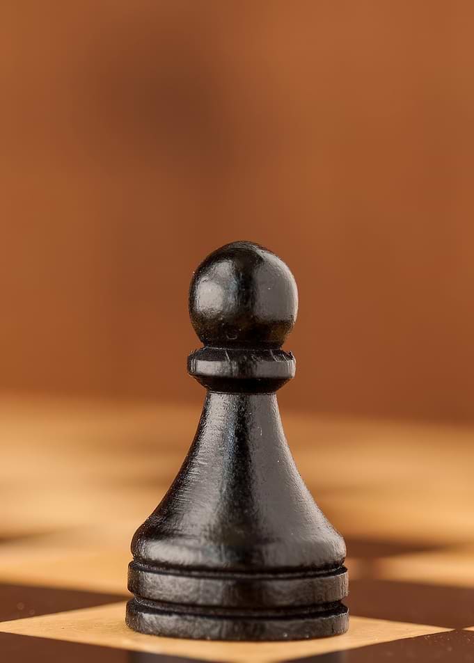 Black Pawn on Chessboard Close-Up