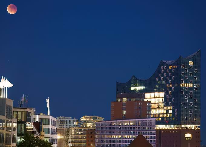 Hamburg cityscape with blood moon over the Elbphilharmonie