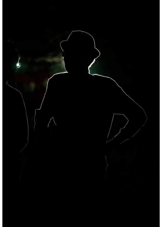 Silhouetted Figures in Dark Setting