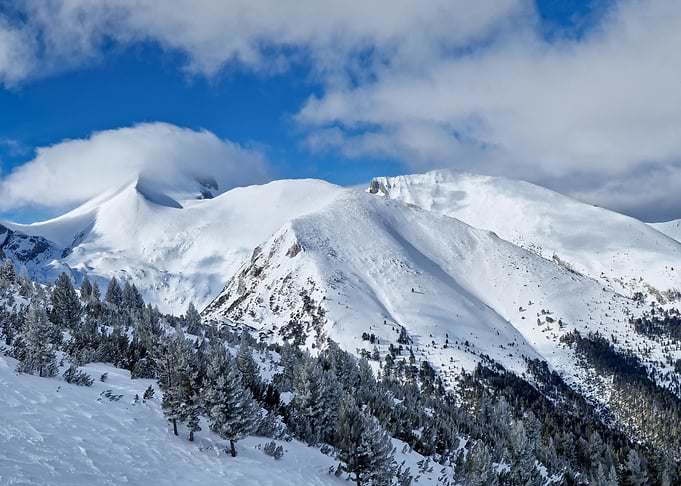 Snowy Mountain Peaks Under Blue Sky