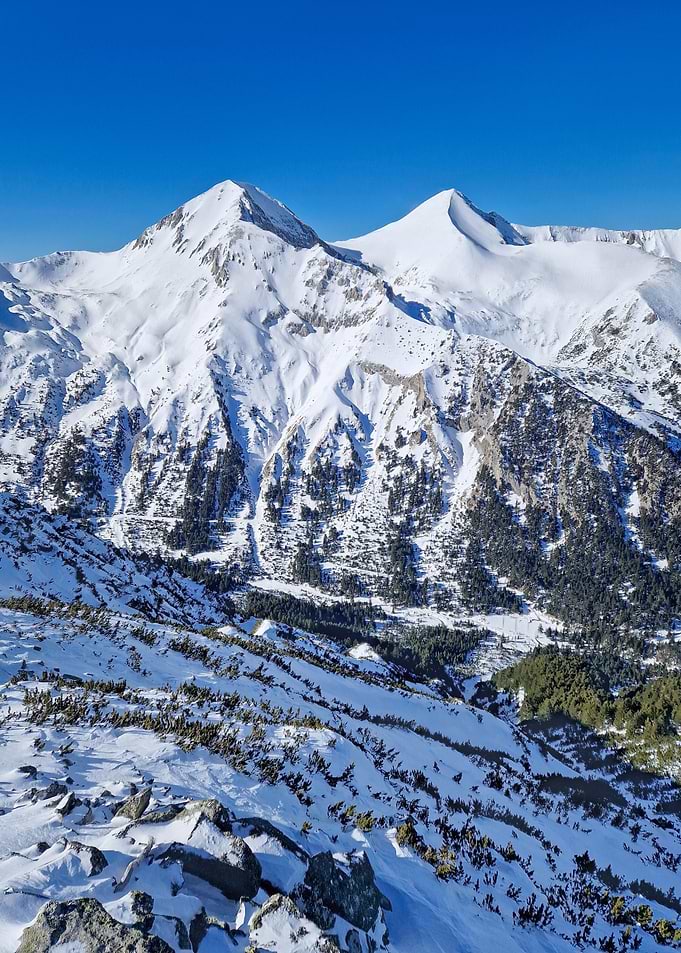 Snowy Mountain Peaks Under Clear Blue Sky
