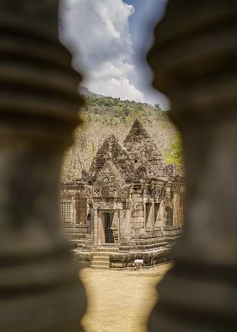 Ancient Temple Ruins Through Stone Pillars