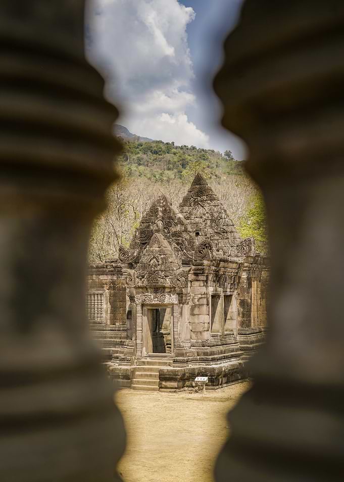 Ancient Temple Ruins Through Stone Pillars