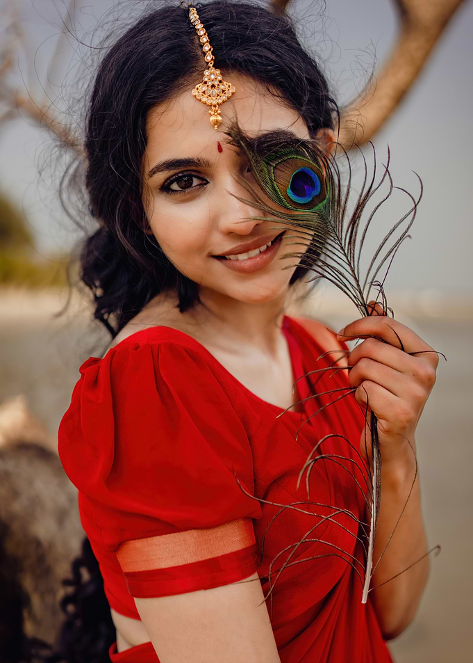 mamitha baiju with Peacock Feather Portrait