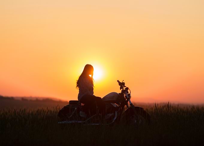 Sunset Ride: Woman on Motorcycle