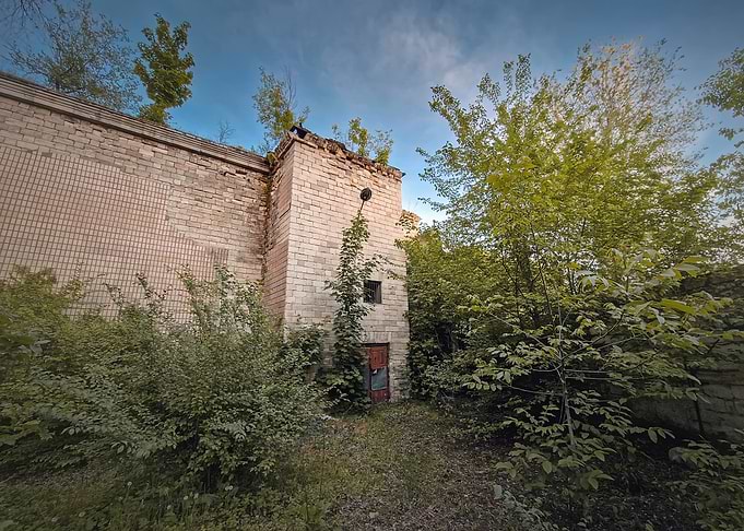 Overgrown Brick Building