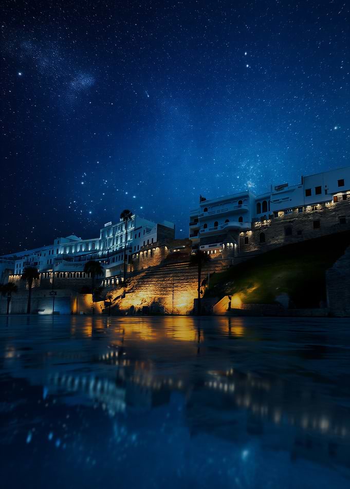 Night cityscape with starry sky reflection