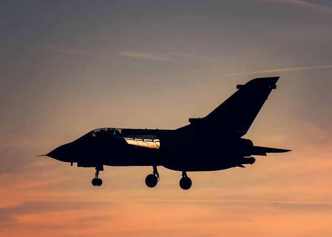 Silhouette of a Fighter Jet at Sunset