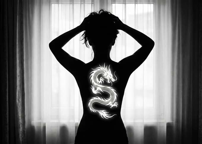 Woman's Back with Dragon Tattoo Silhouette