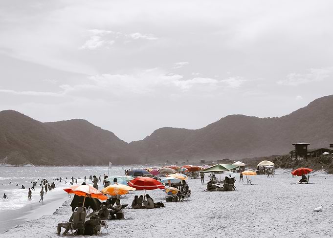 Beach scene black and white with colorful umbrellas