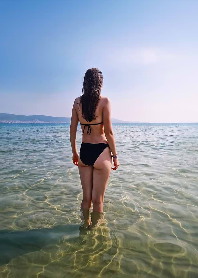 Woman in Black Bikini in Ocean