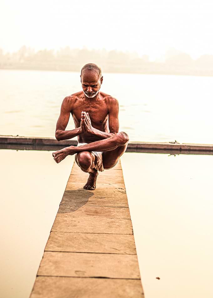INDIA, Yogi doing yoga on a dock